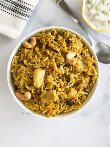 A bowl of Jackfruit biryani is on the table.