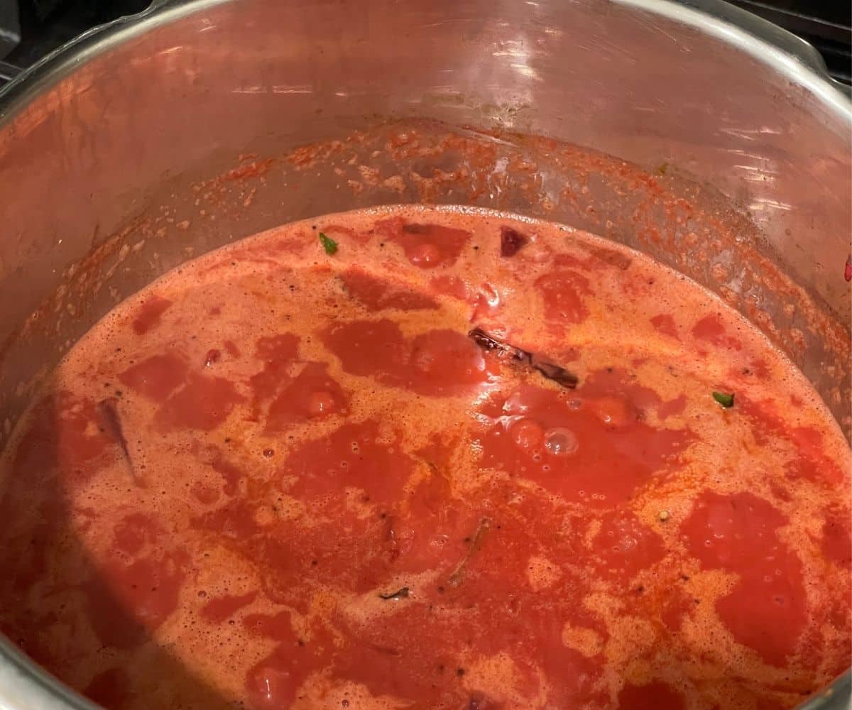 A pot is with cooked Sambar with coconut.