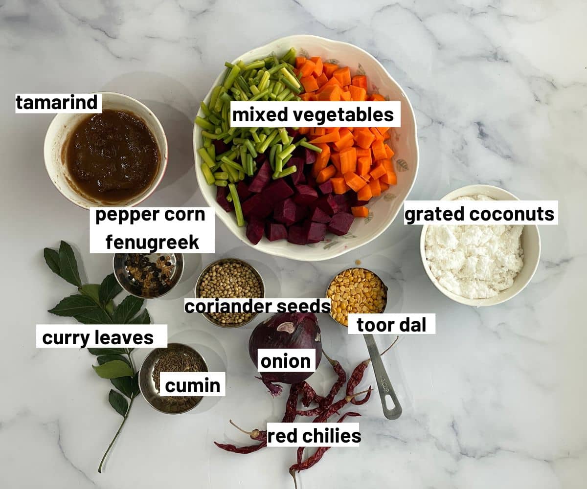 A table is covered with Sambar ingredients.