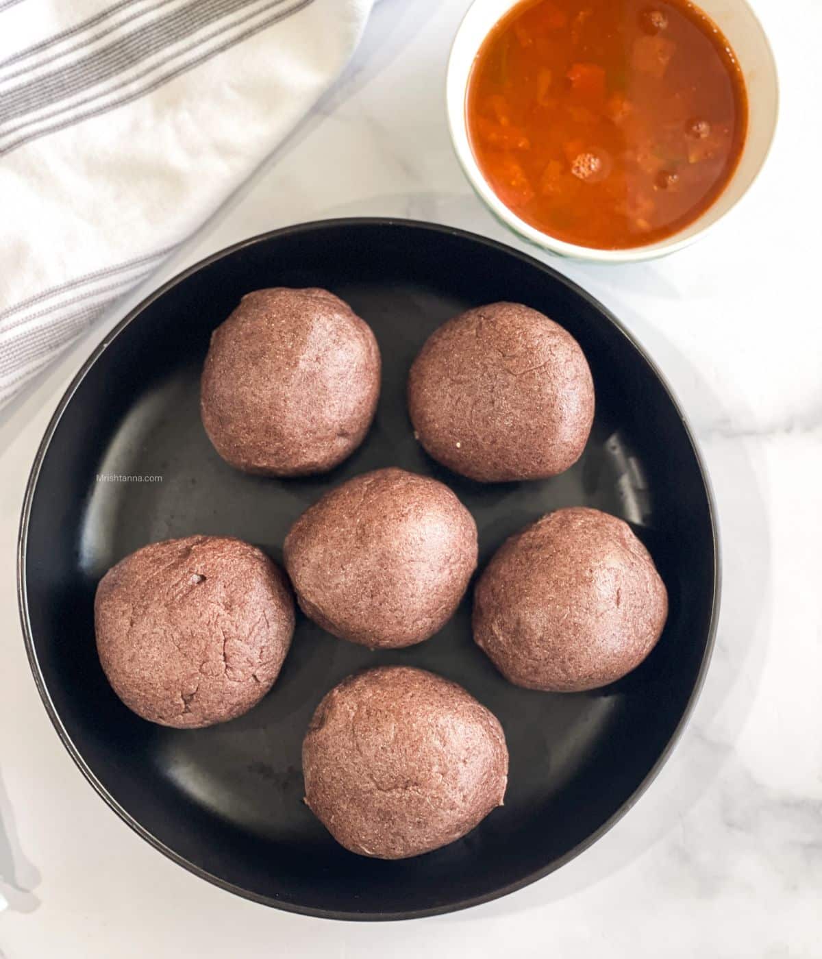 A plate has ragi mudde balls on the table.