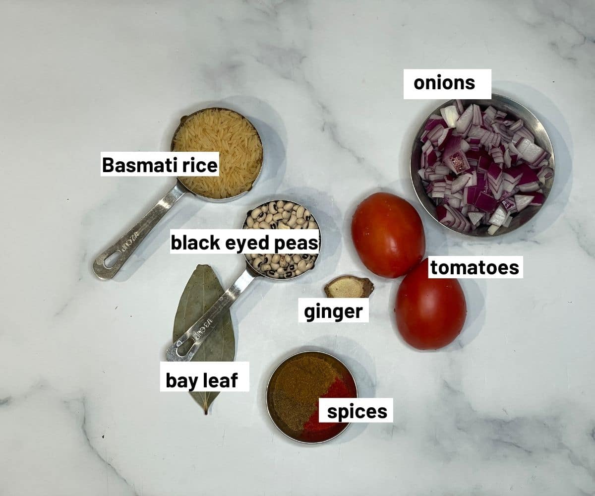 On the table black eyed peas rice ingredients are placed.