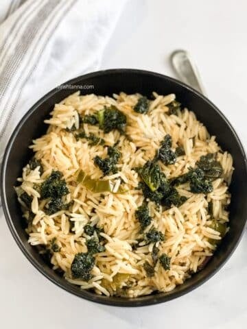 A bowl of kale rice is on the table.