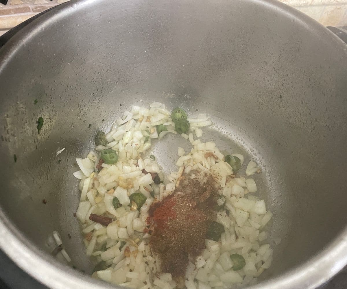 An instant pot has kale rice ingredients.