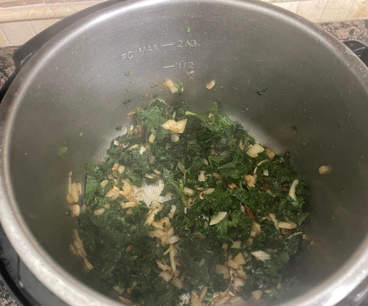 A pot has a kale and spice for kale rice.