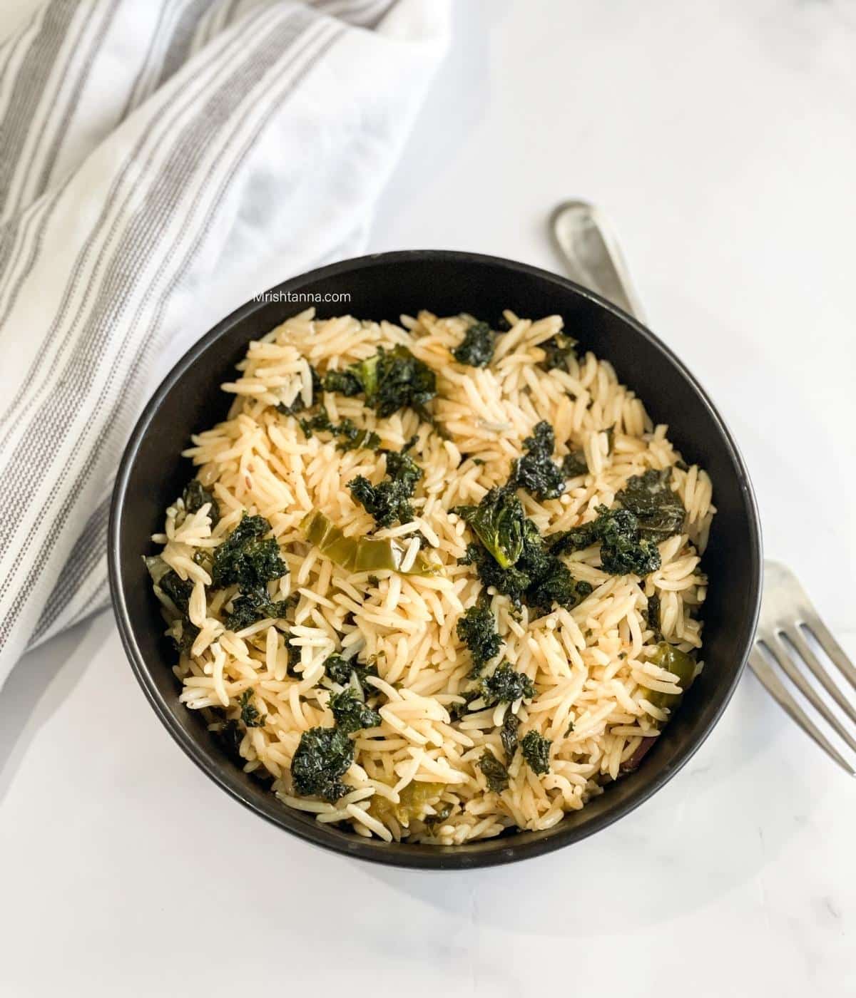 A bowl of kale rice is on the table.