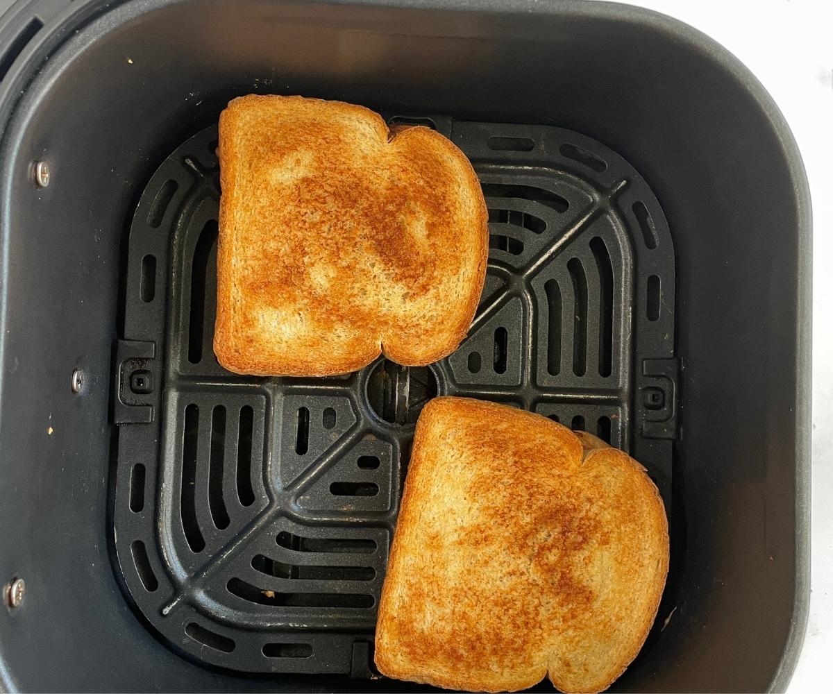 Air fried peanut butter jelly sandwiches are on the basket.