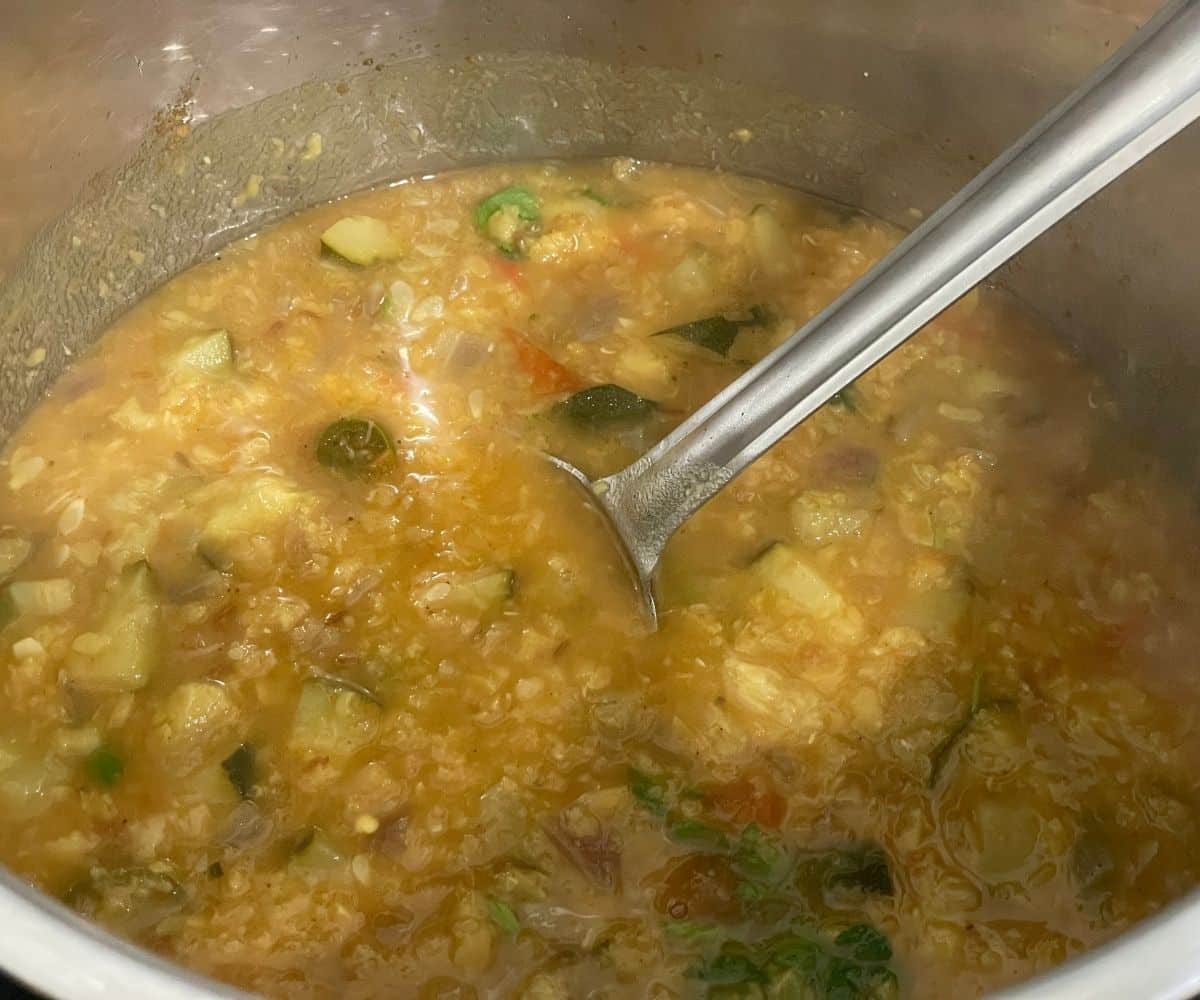 An instant pot has zucchini dal.