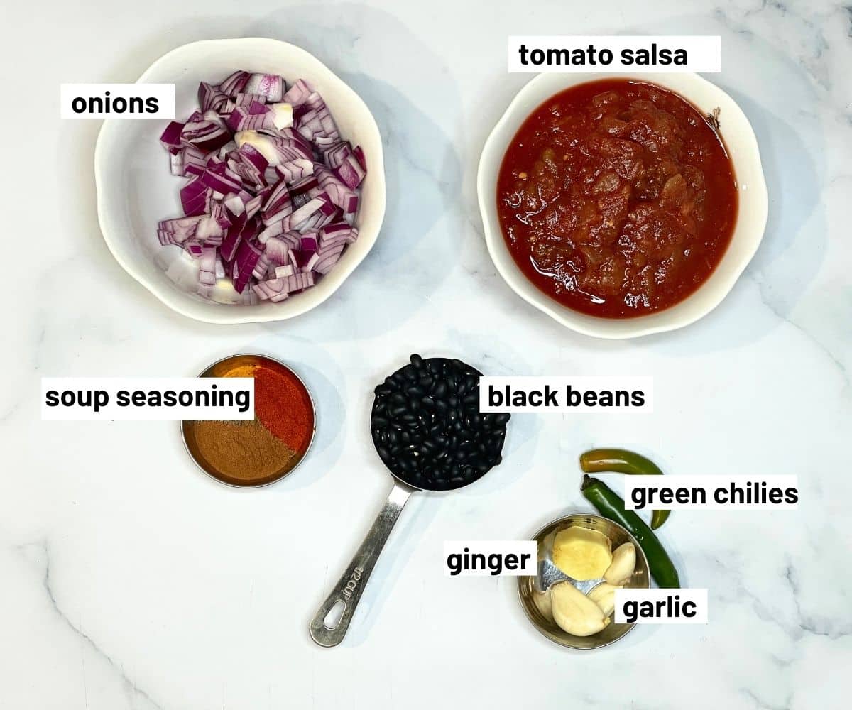 A table is filled with Black bean chili ingredients.