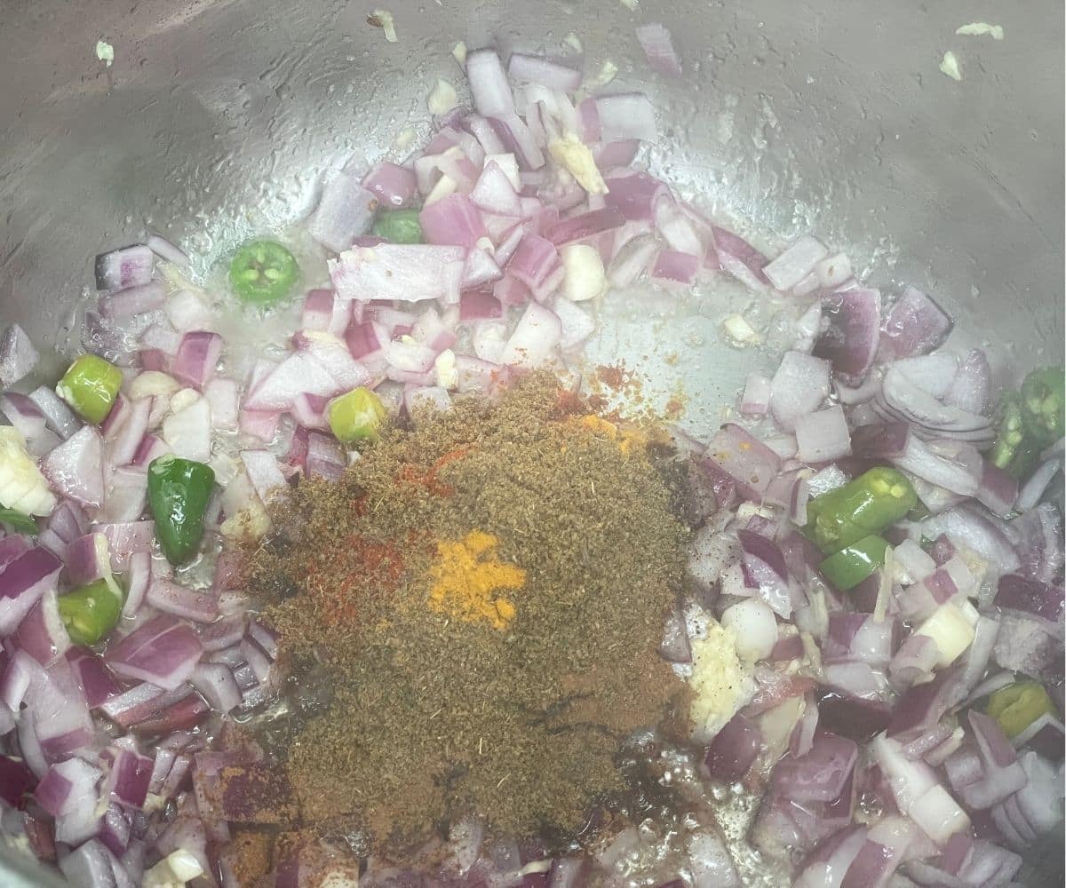 A pot is with spices and vegetables.