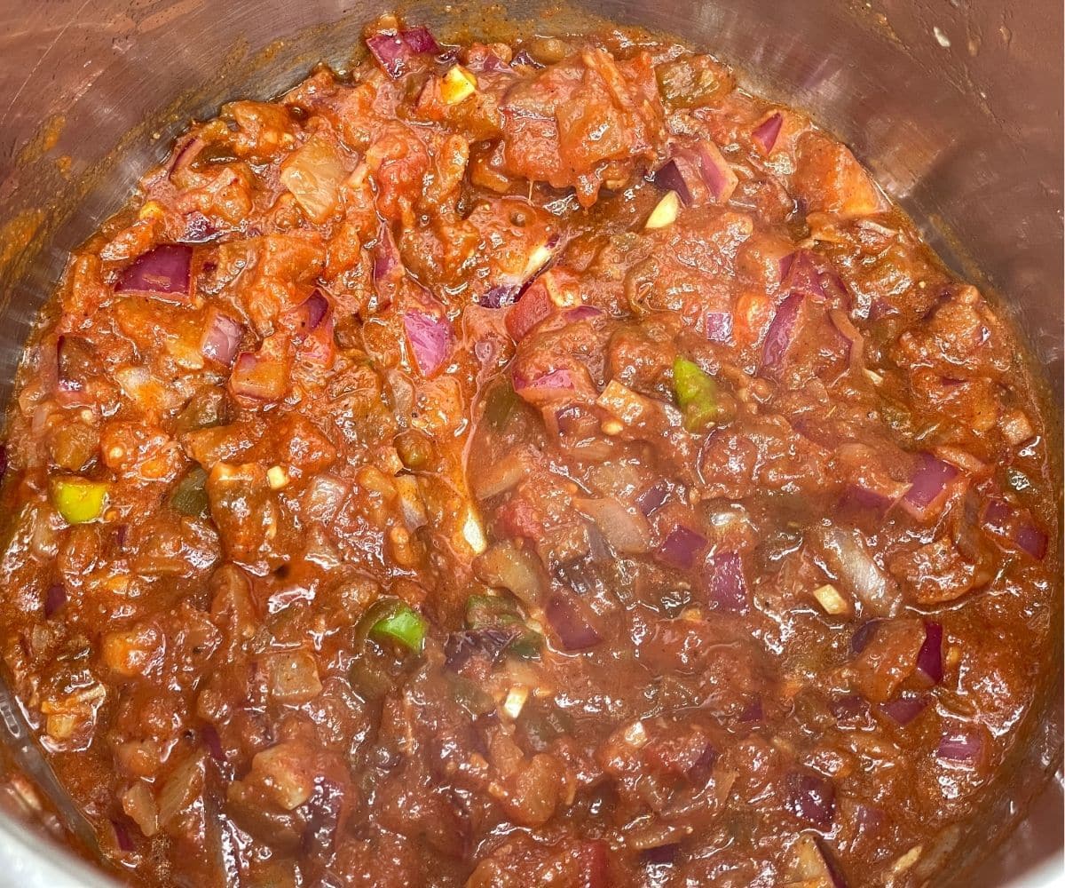 An instant pot is with black bean chili.