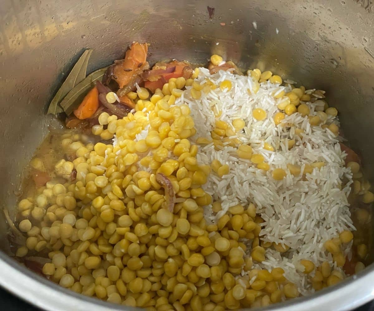 An instant pot has Chana dal and rice for the dal pulao recipe.