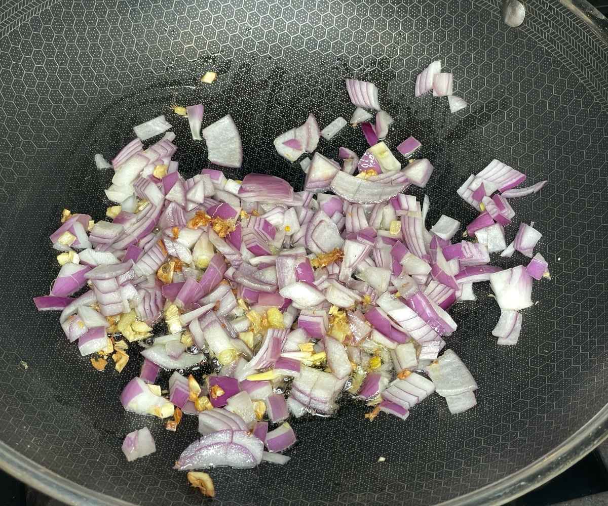 On heated pan garlic, ginger and onions frying for gobi tikka curry,