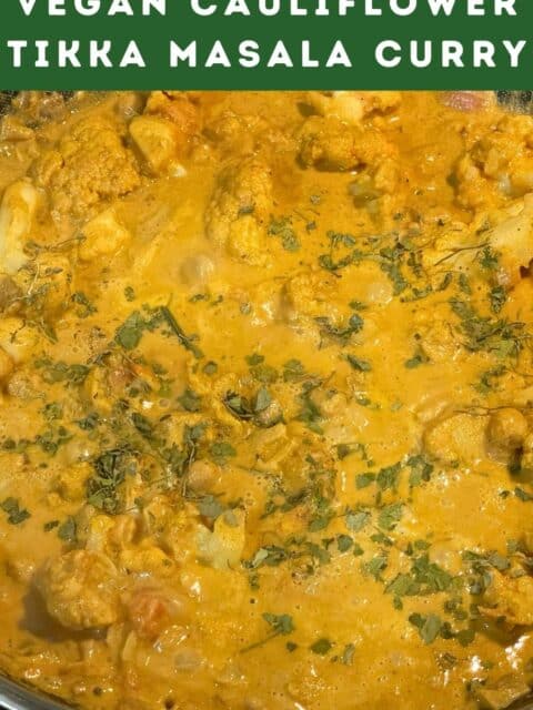 A pan is full of vegan cauliflower tikka masala with chickpeas.